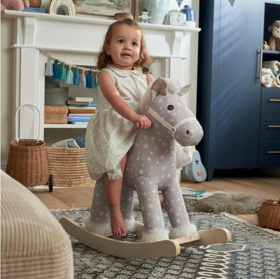 Child on Mamas & Papas rocking horse toy