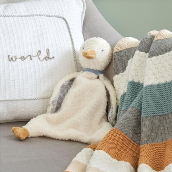 Mamas & Papas soft duck teether toy sat on chair